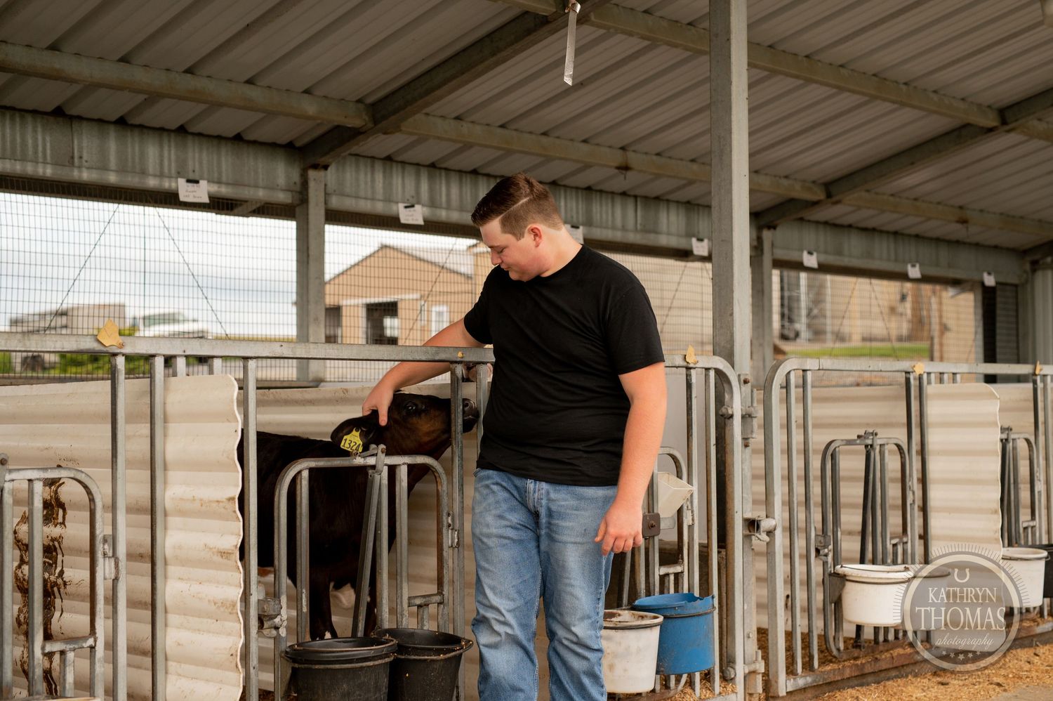 Someone inspects dairy cow stalls in a modern agricultural facility.