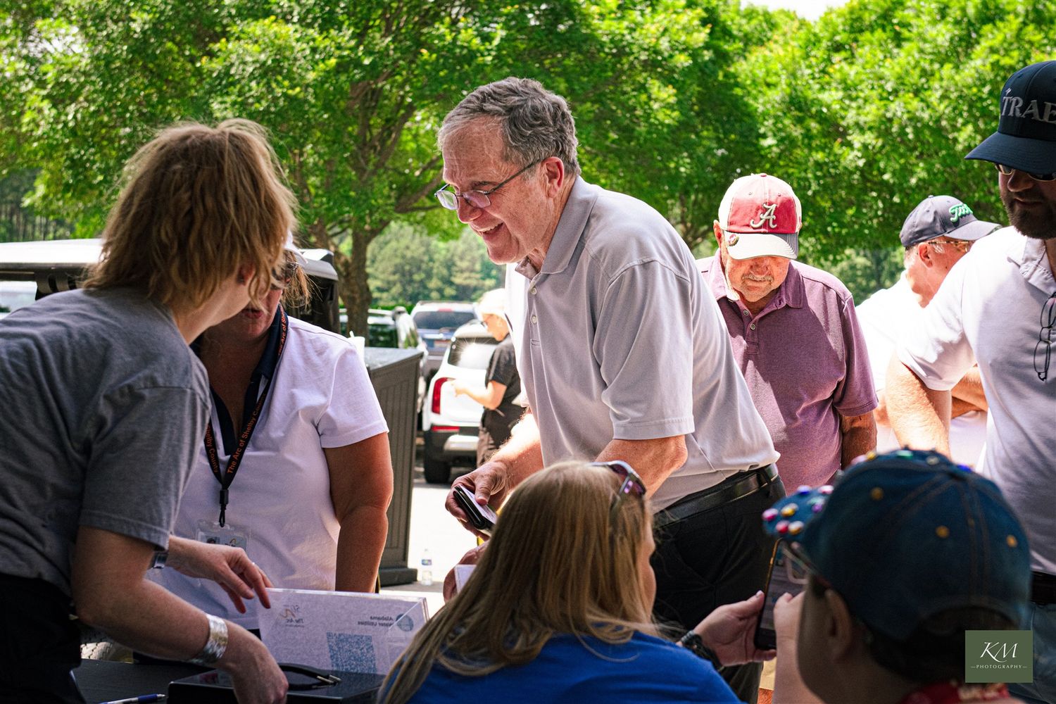 Candid event photography of the check-in desk at golf tournament in Shelby county
