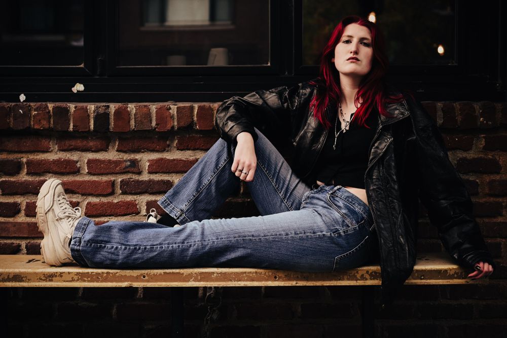 Senior girl sits on bench in Lafayette, Indiana.