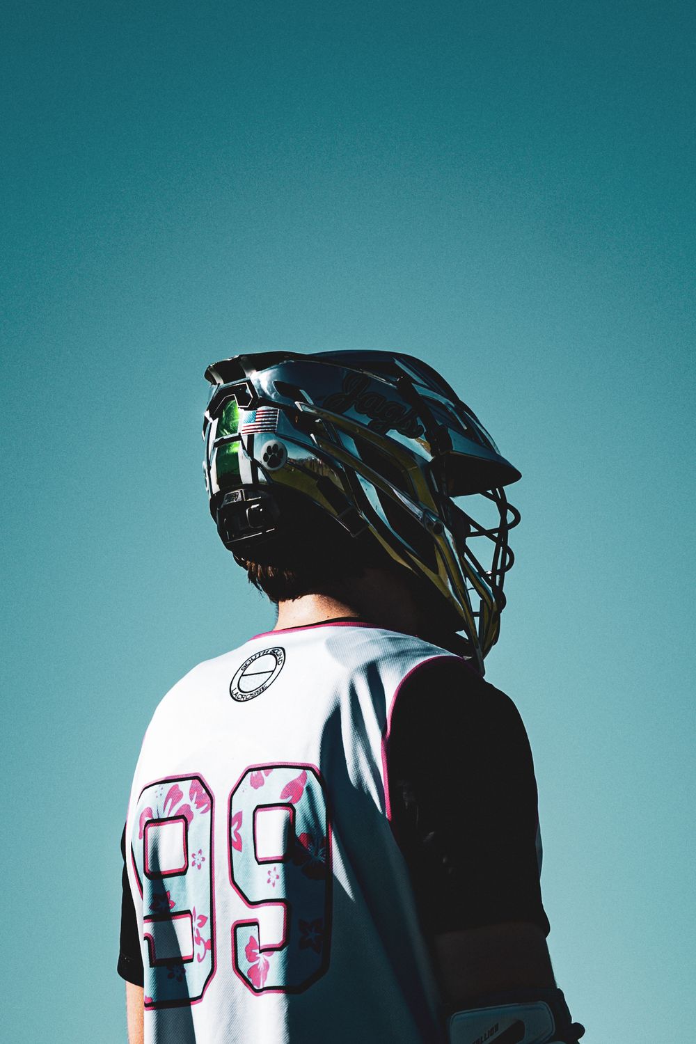 Baseball player in white jersey with number 92 shown in profile against teal background.