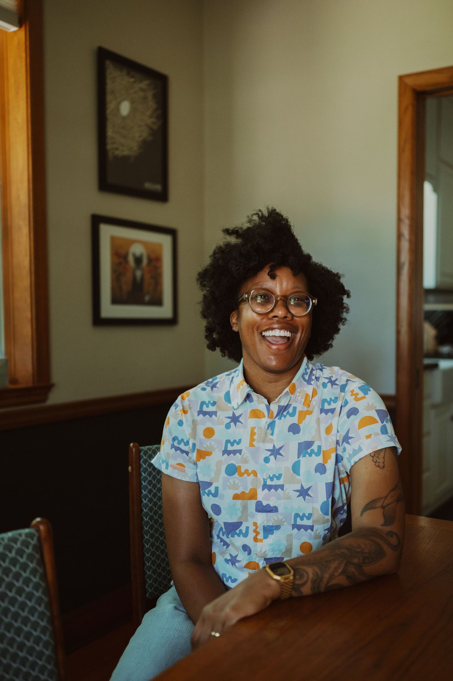 A series of candid photos showing someone wearing glasses and a patterned button-up shirt sitting at a wooden table.