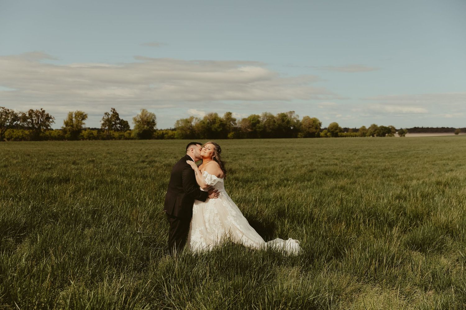 Romantic sunset portrait of a couple embracing in a sunlit garden.
