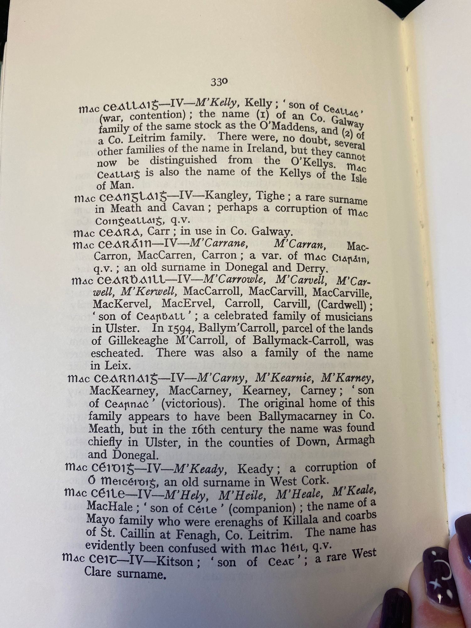 Book page displaying alphabetical entries of Celtic family name origins.
