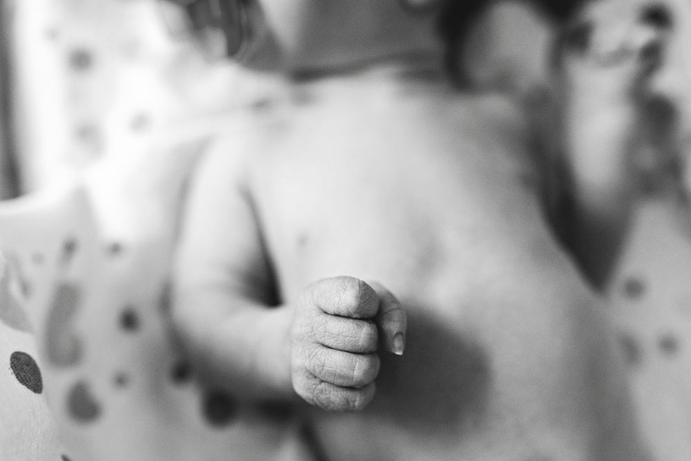 Fresh 48 session capturing newborn baby fist
