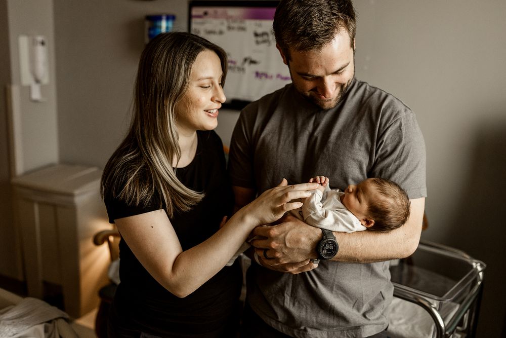New mom and dad dote of their newborn baby boy at their fresh 48 session in Tulsa,OK