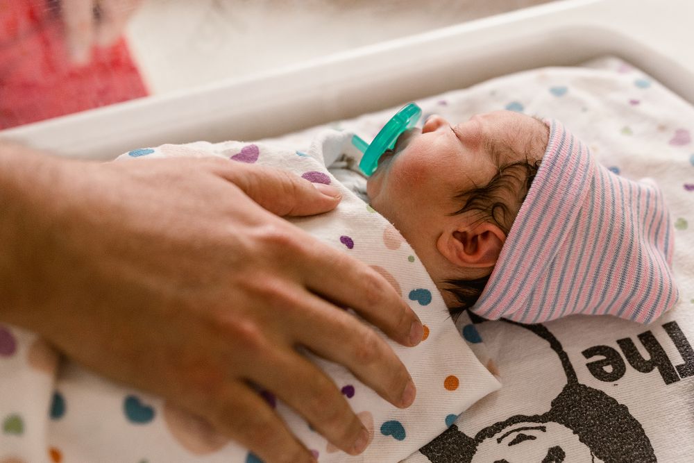 dad holding his newborn son at his fresh 48 session in Tulsa