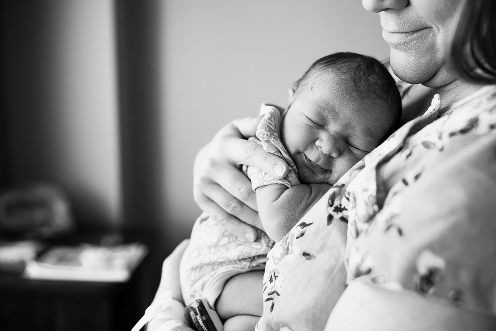 newborn baby snuggled up on her moms chest at their fresh 48 session