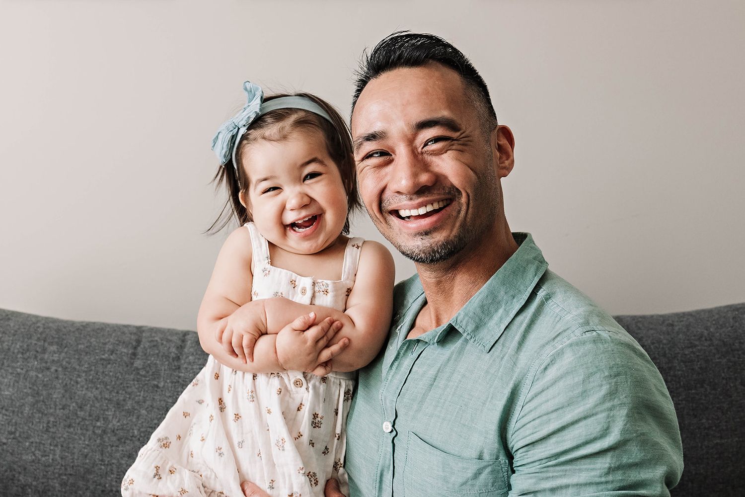 Photograph of a family with a father and daughter sharing laughter together in their home near Lemoyne PA in Cumberland County PA
