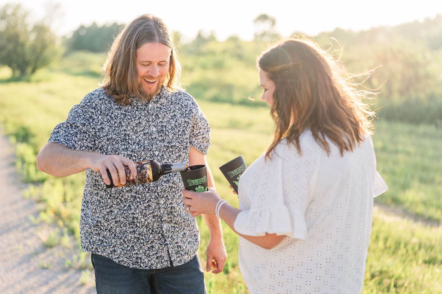 Engaged couple pouring darklord beer during their Kenosha engagement session.