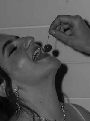 Black and white photo series showing a person tilting their head back while wearing decorative earrings.