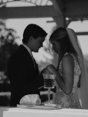 Black and white wedding reception scene showing celebration drinks and elegant table settings in a cozy venue.