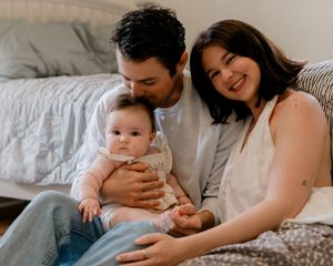 A series of intimate family moments captured on a white bed showing tender parent-child interactions and bonding.