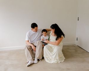 A series of minimalist photos showing a couple sitting together on a white floor against a white wall.
