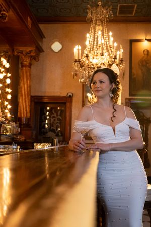 Elegant ballroom setting with crystal chandeliers and polished wood floors creating a warm, romantic atmosphere.