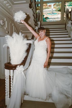 A series of photos capturing a person in a white wedding gown dancing and spinning on a grand staircase.