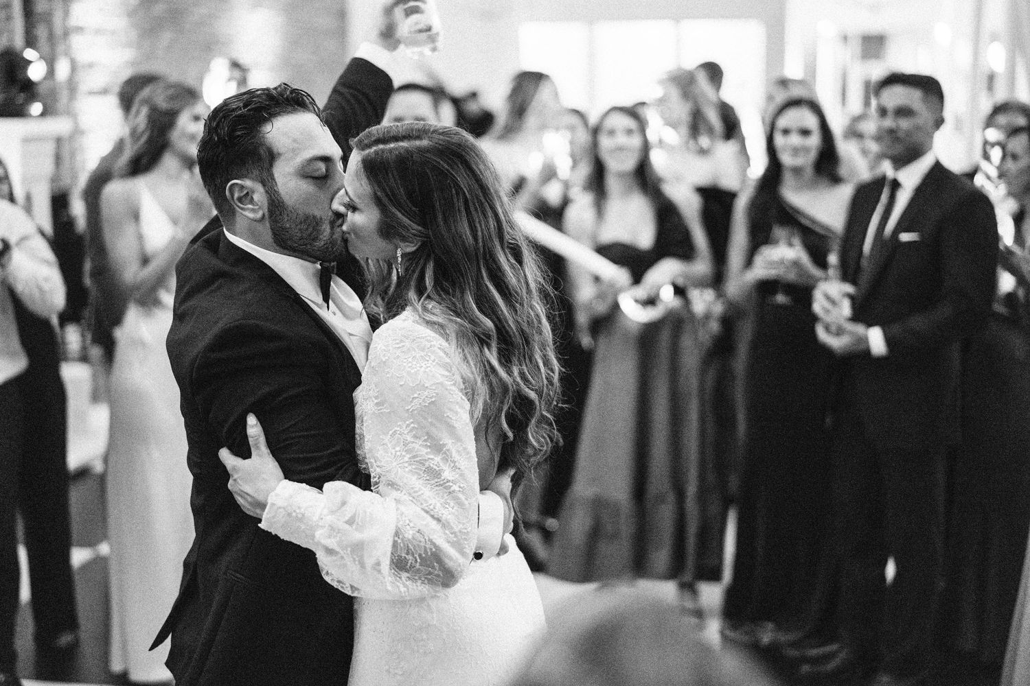 Black and white photo of couple's first dance at wedding reception.