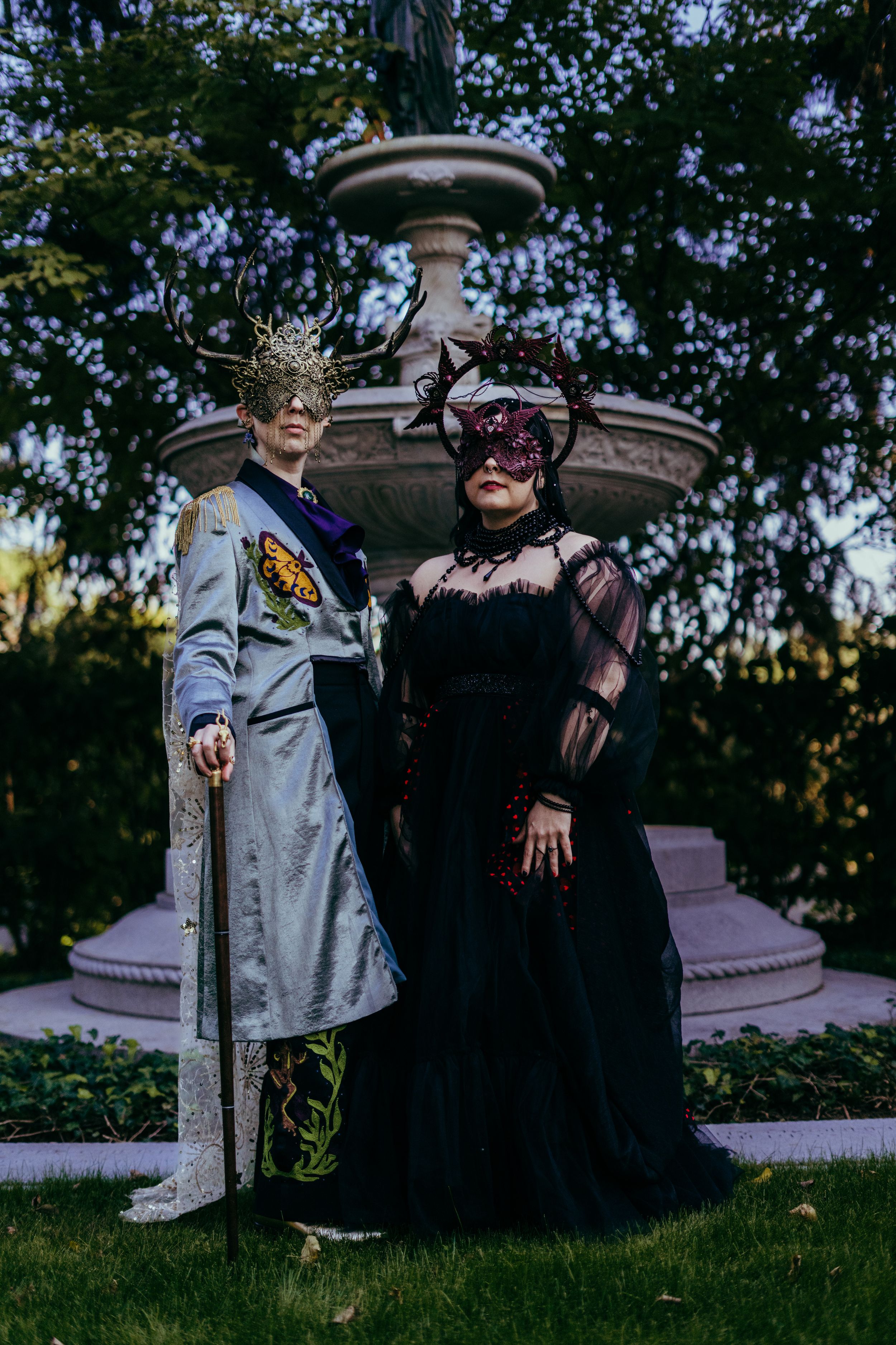couple pose by fountain