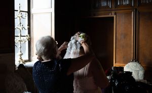 mother adjusting bride's veil