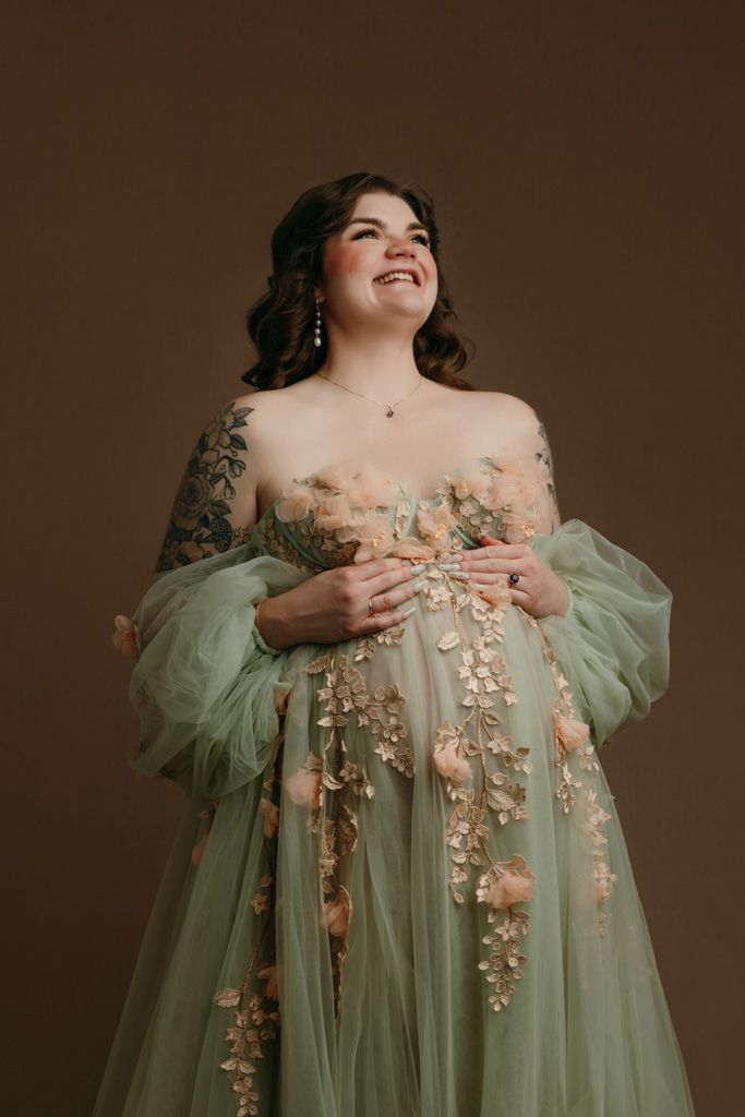 A dreamy portrait series in sage tulle gown with delicate floral appliques against a moody backdrop at the maternity studio in Victoria BC
