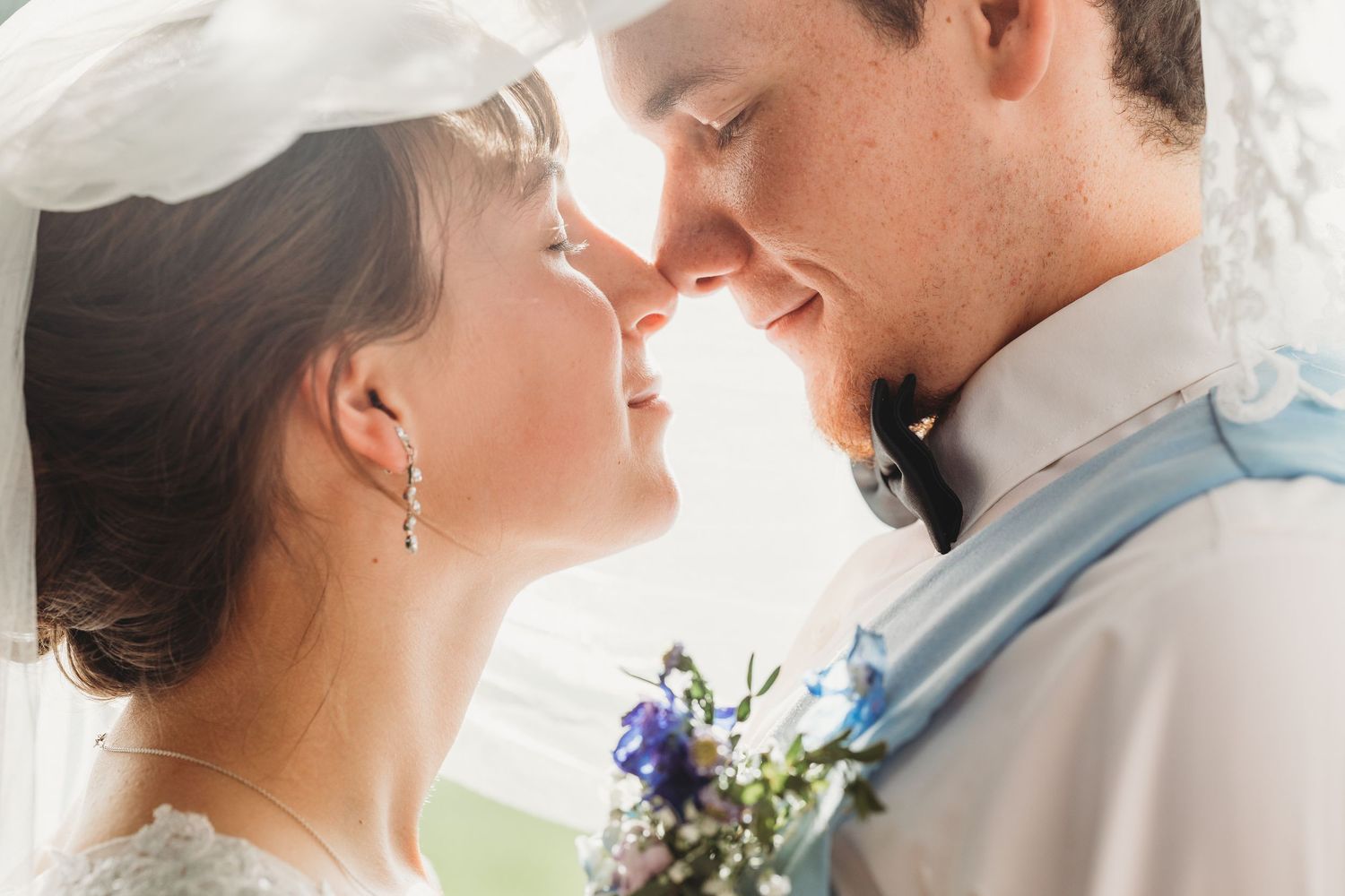 Delicate white roses and baby's breath flowers arranged in a romantic wedding bouquet.