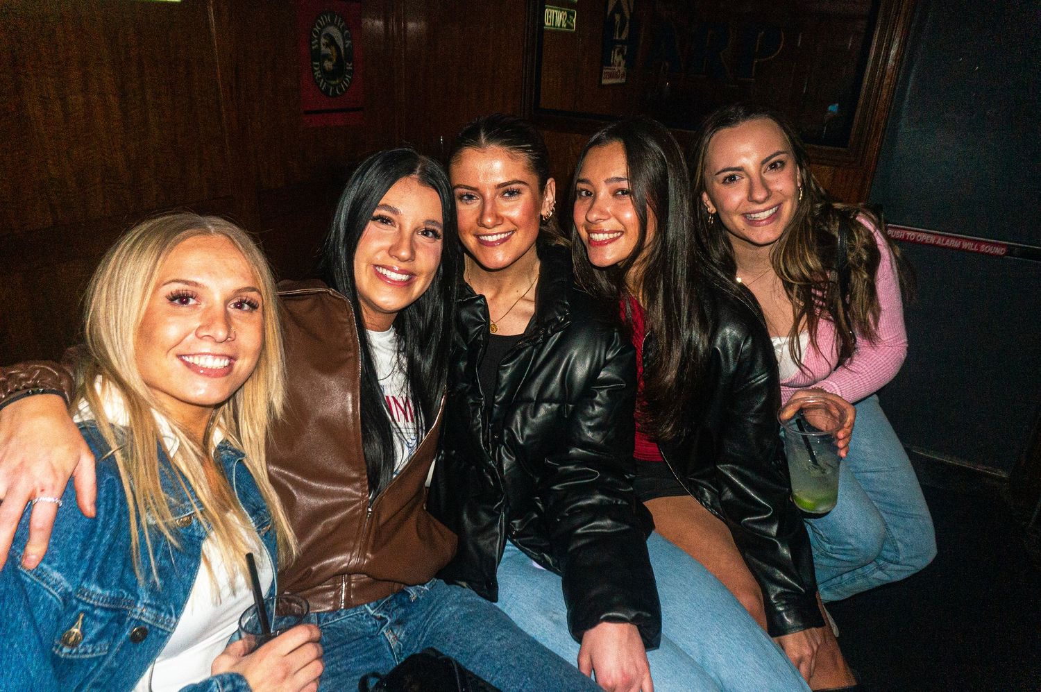 A group of friends enjoying a night out together in a dimly lit venue.