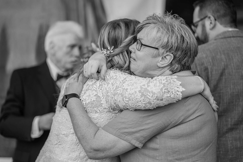 Black and white photo series showing tender dance moments between two people at what appears to be a wedding reception.