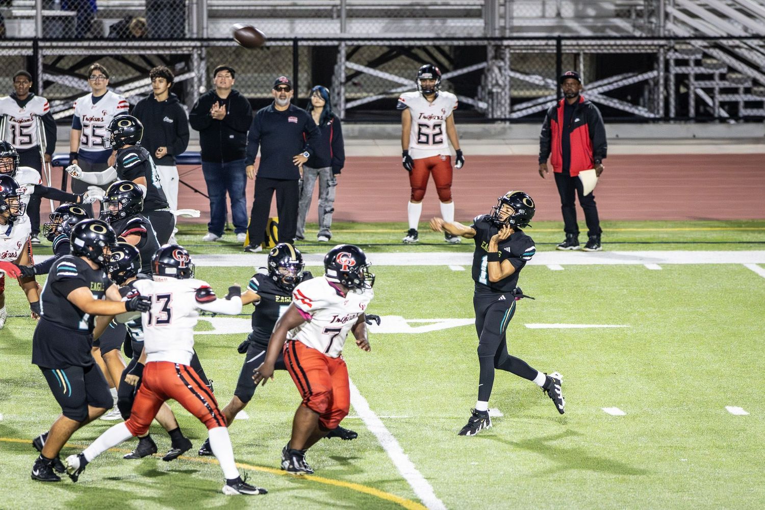 San Diego sports photography of a high school football quarterback throwing a pass during a game under stadium lights