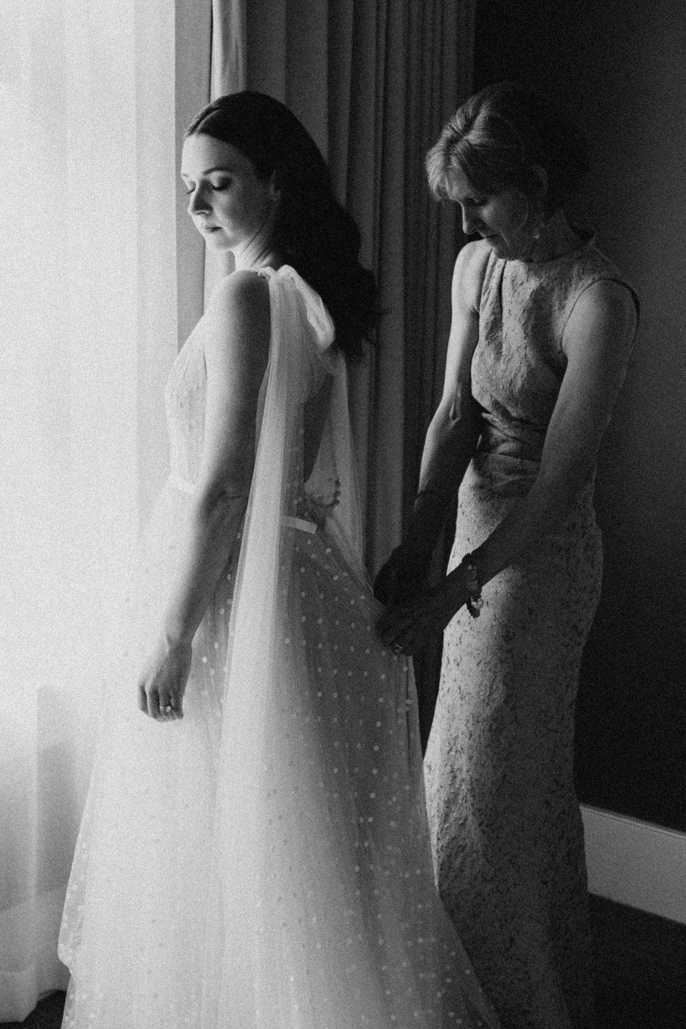Series of moody silhouette shots showing a bride's dress and veil in dramatic lighting.