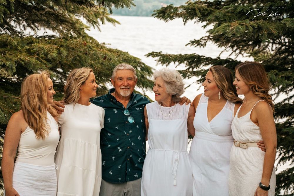 Multi-generational looking at each other in front of Charlie Lake in FSJ
