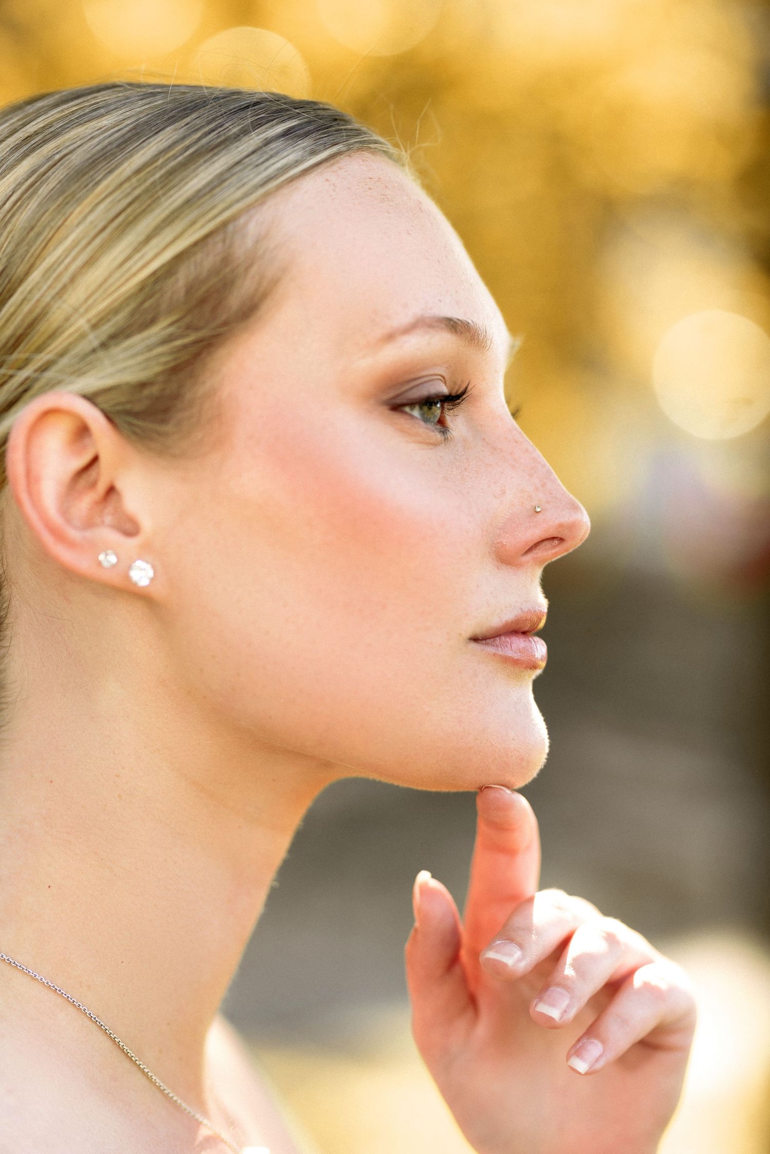 Profile views showing elegant facial features with warm autumn lighting.
