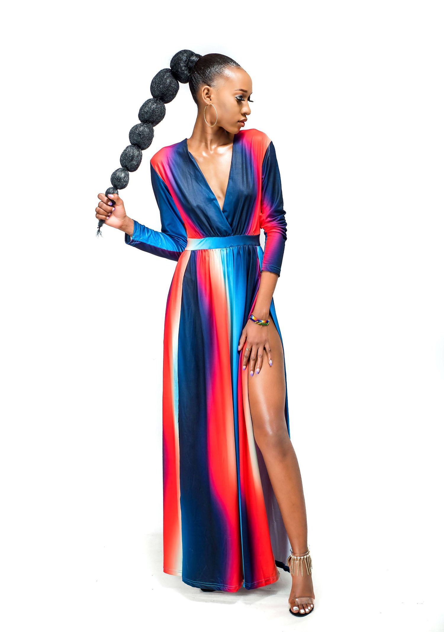 Stunning multicolored striped maxi dress with thigh-high slit and dramatic braided hairstyle.