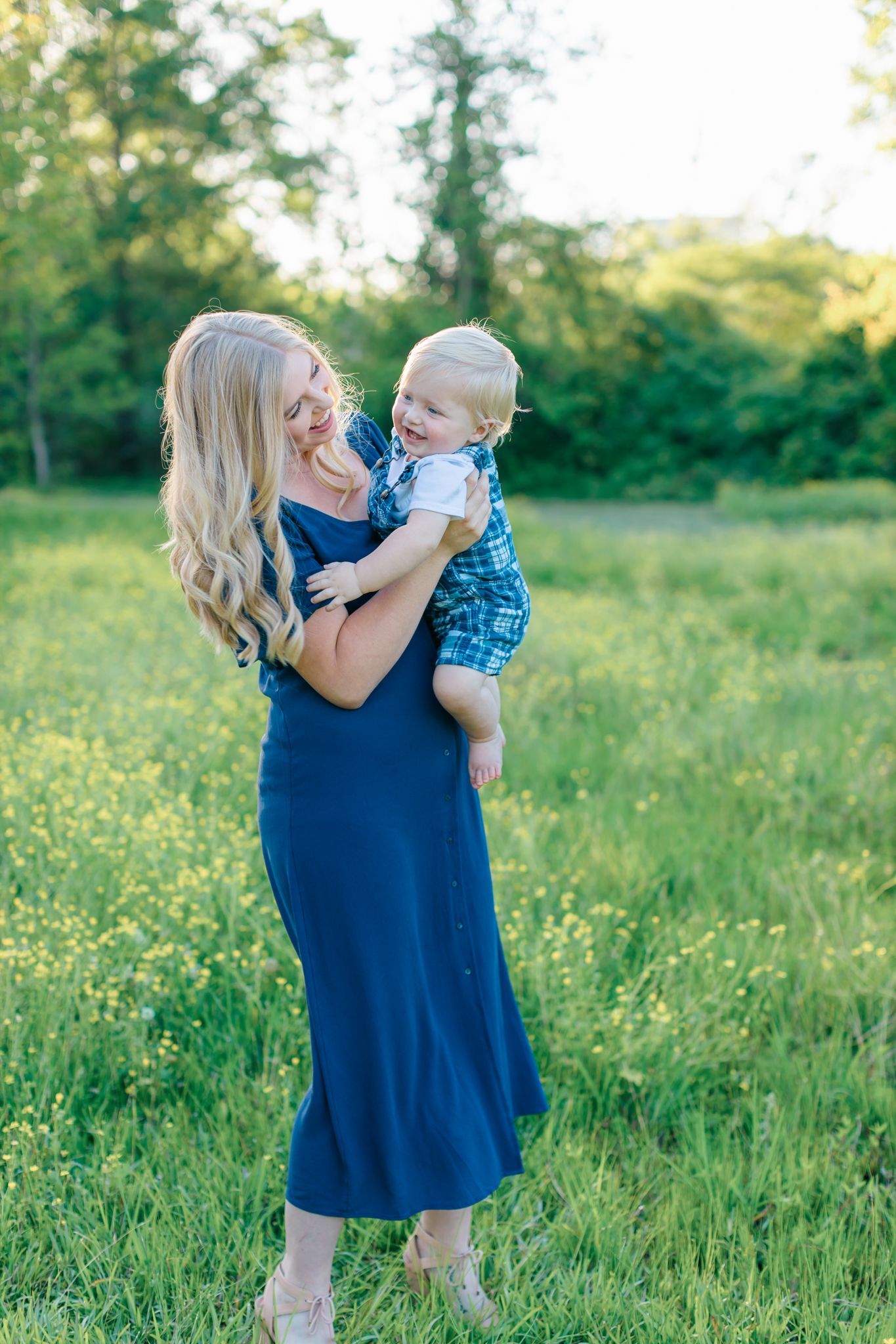 mother and child smiling in field