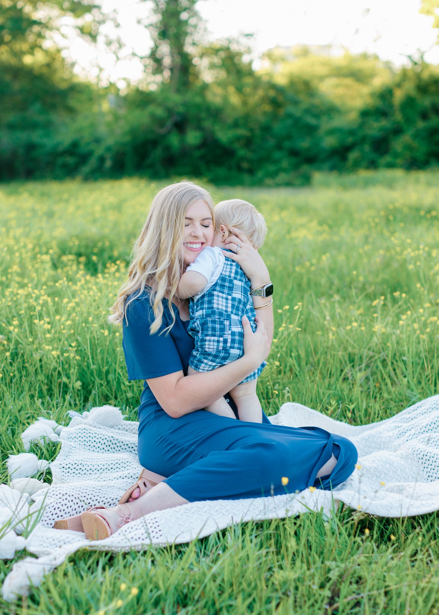 mom and baby sweet hugs in field