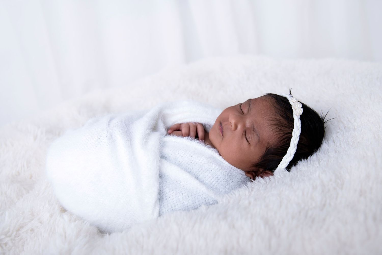 pretty cute little newborn girl wrapped so snug