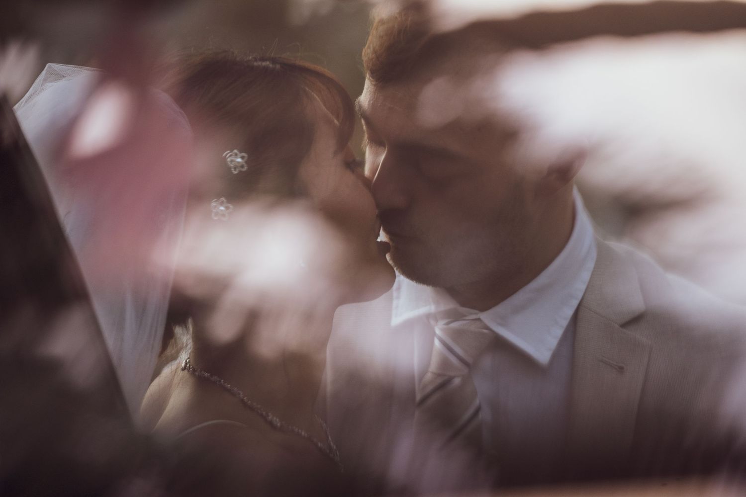 Intimate wedding moments photographed with soft focus and dreamy lighting effects.