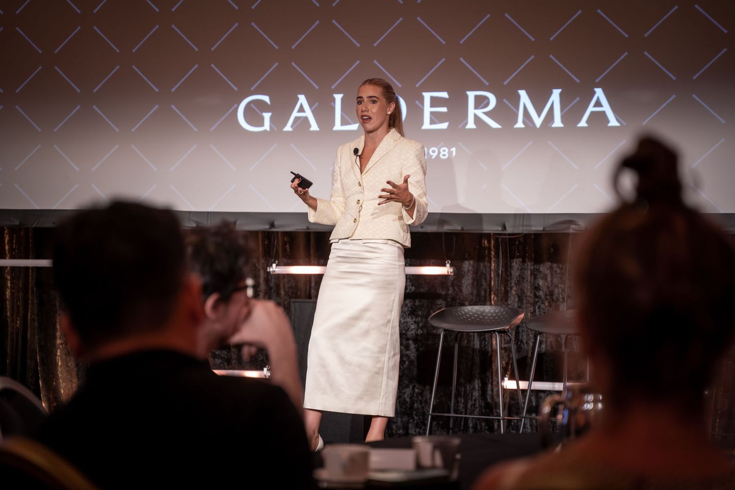 Modern gallery space with 'GALDERMA' signage displayed prominently.