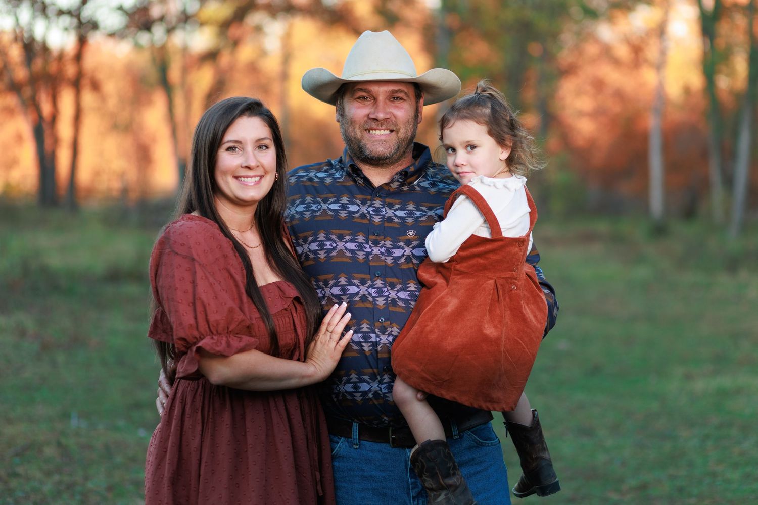Toledo, Illinois family posing in front of an autumn forest.