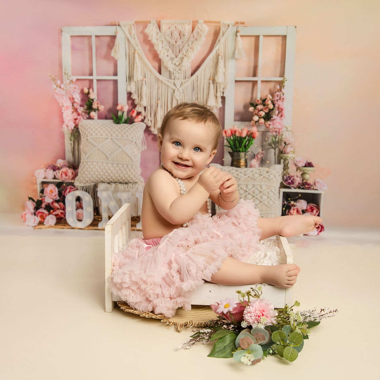 CAKE SMASH PHOTOSHOOT  next to a pink and peach floral bouquet on a neutral background. WOLVERHAMPTON PHOTOGRAPHER