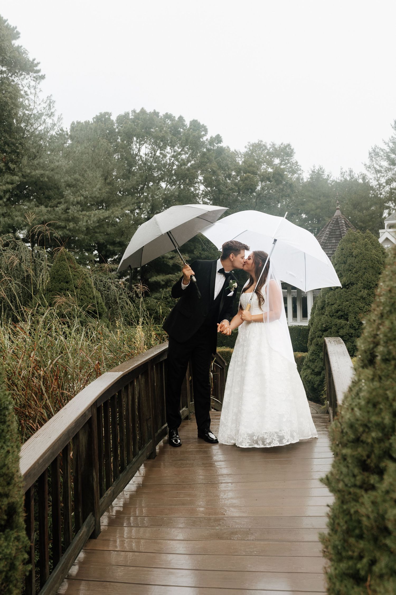 An intimate wedding moment captured as newlyweds share their first kiss.