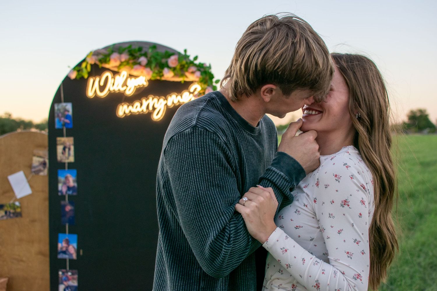 a couple laughing as they walk in a family photoshoot in Marana, Arizona with a ranch and desert plants in the background