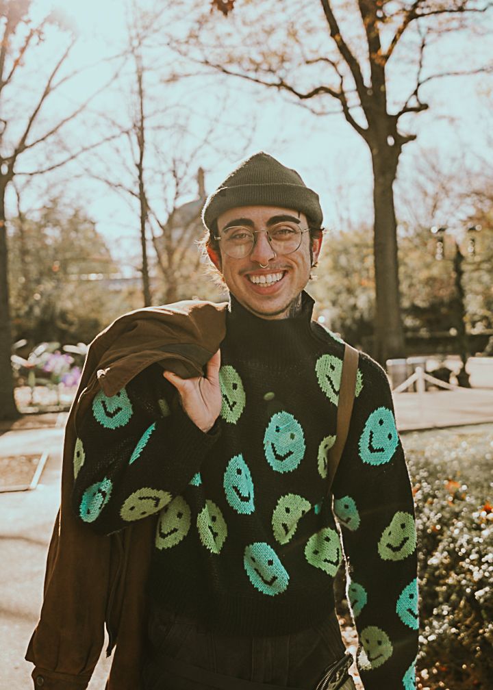 a self portrait of a photographer smiling into the camera while at the zoo