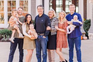 Multi-generational family portrait in front of elegant home with babies and young children.