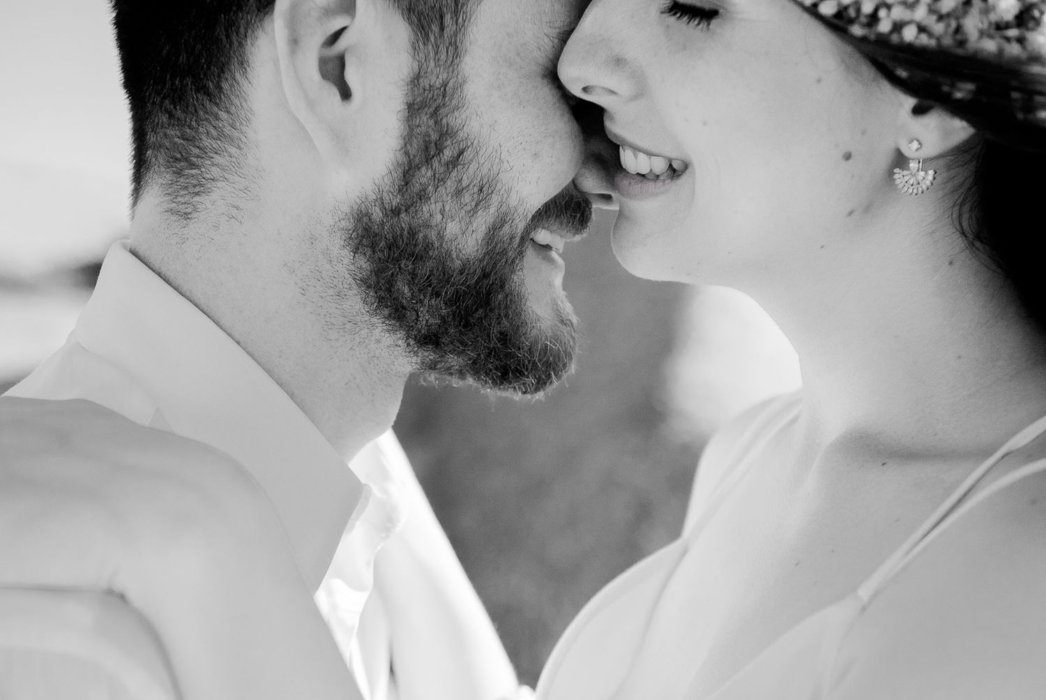 Romantic black and white close-up portrait showing tender moment between couple.