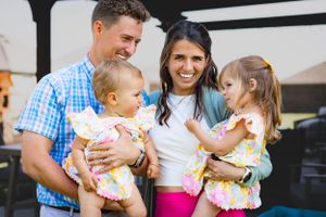 Family having fun together outdoors in casual summer attire.