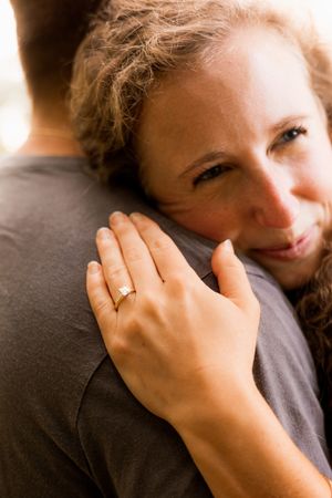 Close-up series showing hand with engagement ring in playful poses.