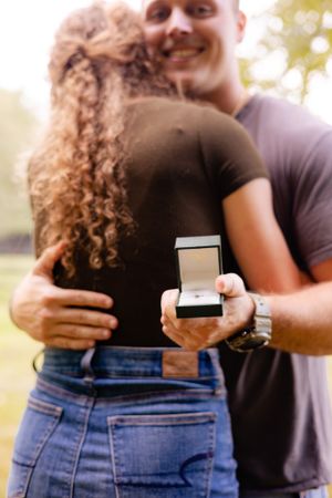 Series showing couple with engagement ring during outdoor proposal photoshoot.