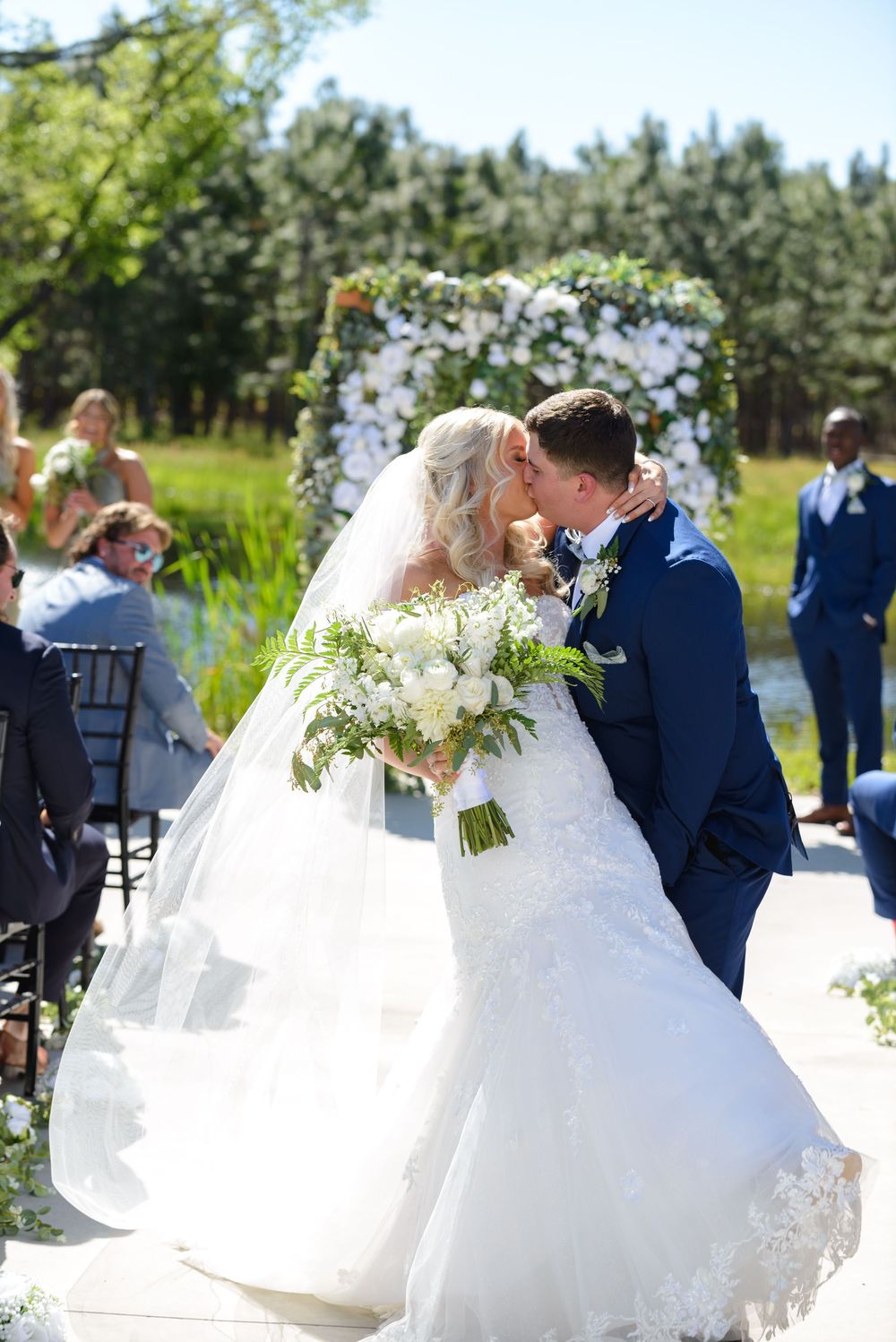 A panoramic collage of an outdoor wedding celebration with flowing white gowns and navy suits against a natural backdrop. little red wagon f