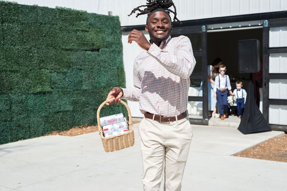 A line of candid photo moments at an outdoor event with greenery in the background.
