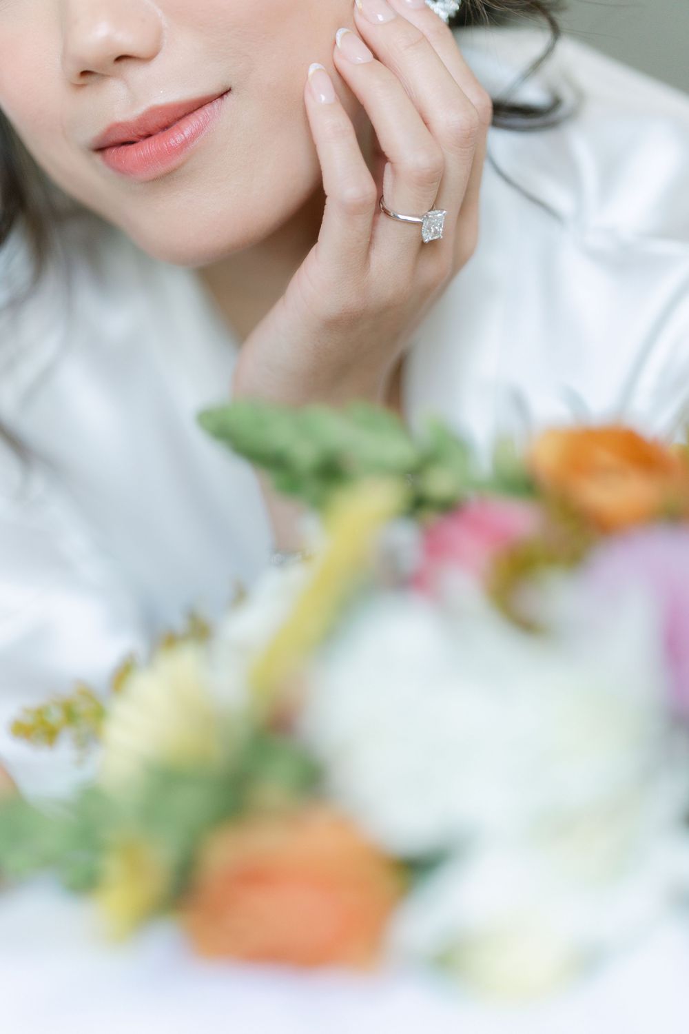 close up bridal portrait highlighting soft makeup and wedding florals