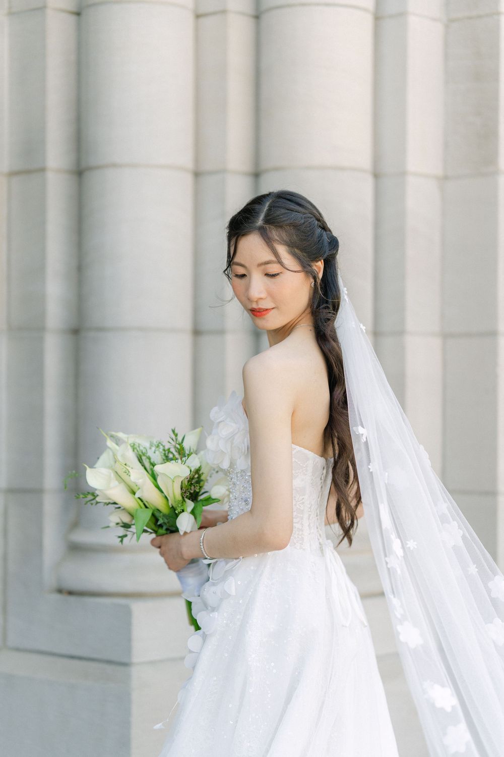 bride holding a white floral bouquet during an elegant wedding portrait